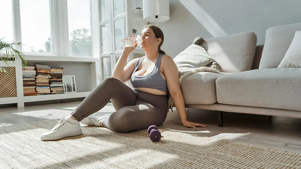 Woman Drinking Water After Yoga